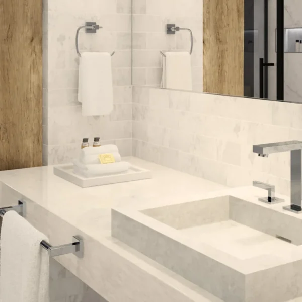 Hotel bathroom vanity with chrome faucet and matching towel accessories