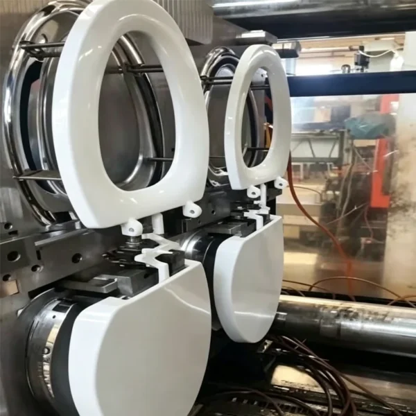 Jekare molded toilet seat component fresh from injection molding