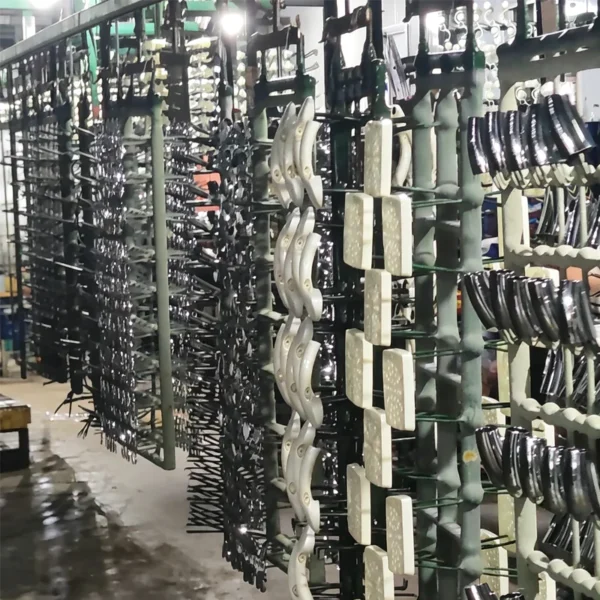 Jekare shower head components hanging on a plating rack before finishing