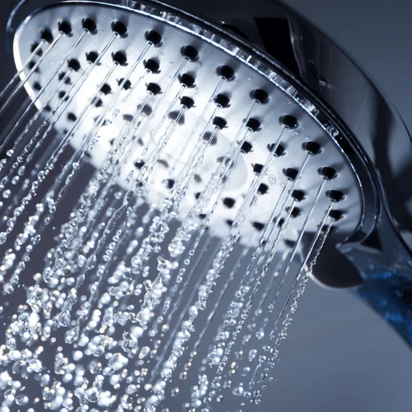 Water-saving shower head spray pattern in a modern bathroom