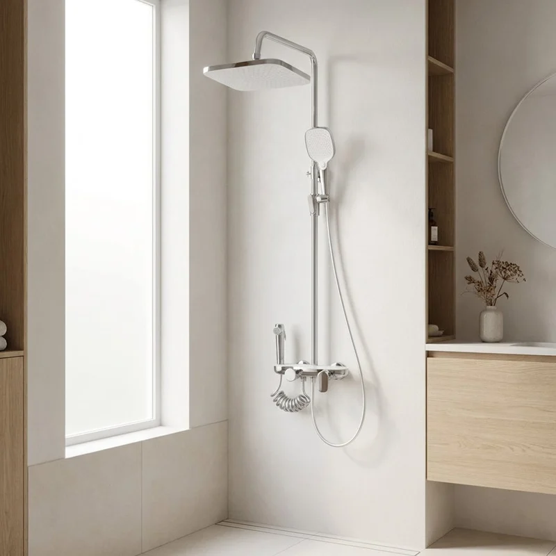 Polished chrome 4‑in‑1 shower column set, square rainfall shower head, handheld shower and bidet sprayer in bright minimalist modern bathroom