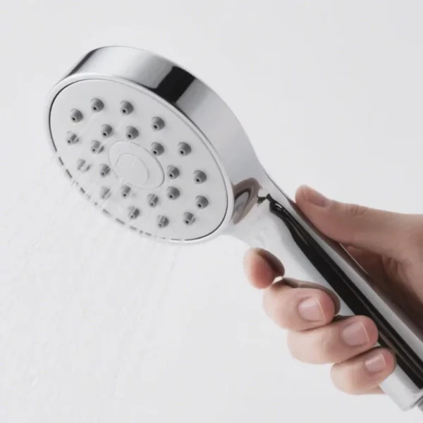 Chrome handheld shower head spraying water
