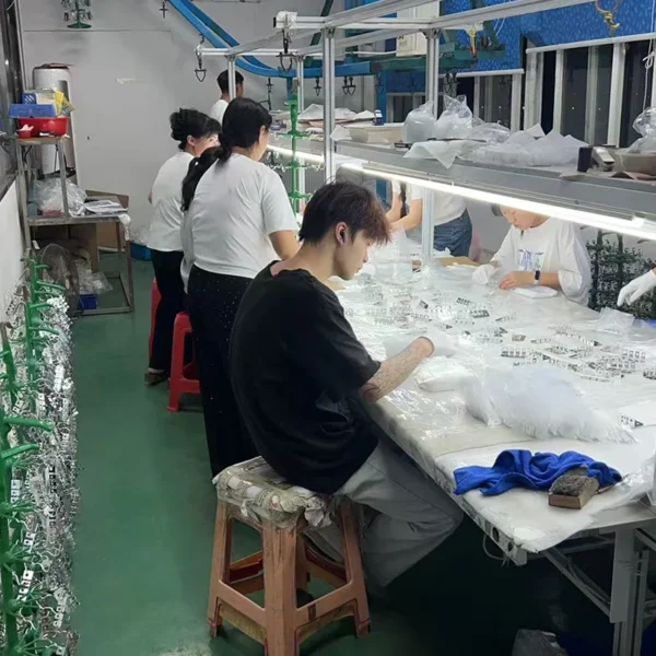 Workers perform quality inspection for bathroom accessories at factory assembly line