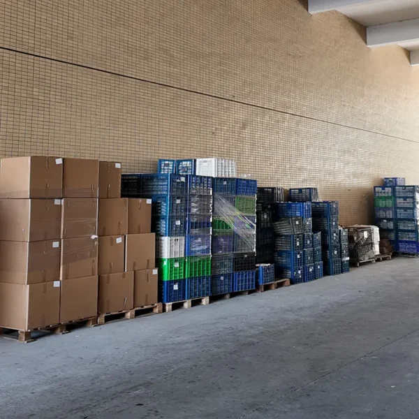 Factory warehouse storage area with packed cartons and crates of finished bathroom products