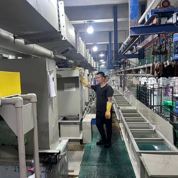 Jekare electroplating workshop interior, staff operating metal surface treatment equipment